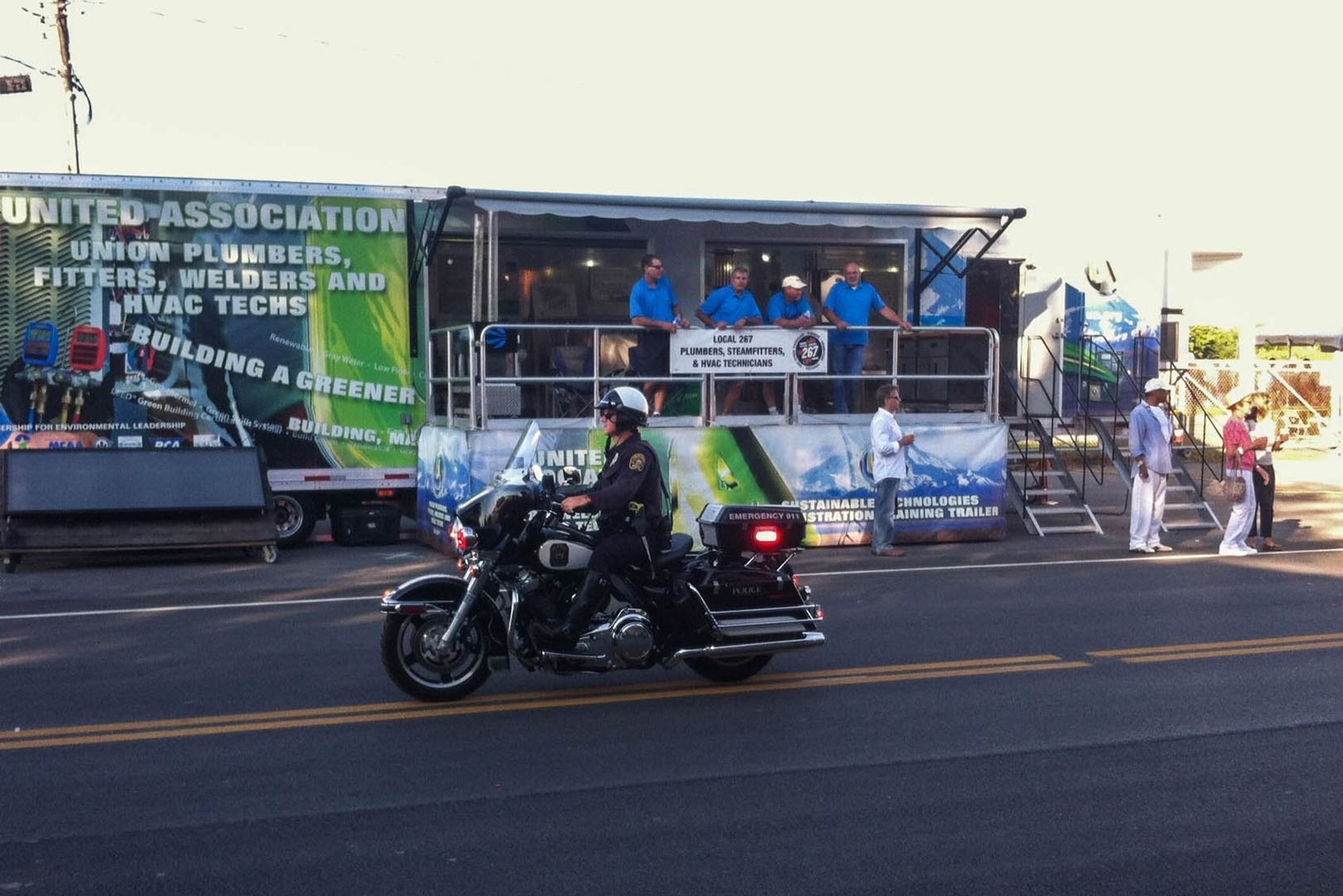 An officer rides a motorbike down the road